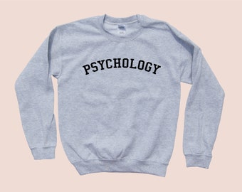 May include: A gray sweatshirt with the word "PSYCHOLOGY" printed in black across the chest.