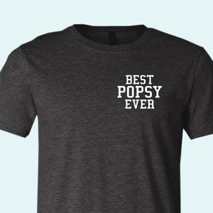 May include: Dark gray t-shirt with white text that reads "BEST POPSY EVER".