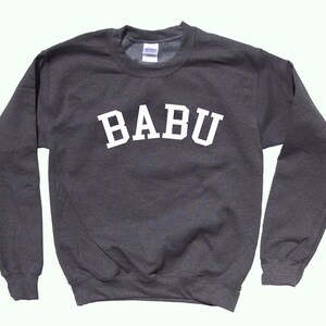May include: A dark grey sweatshirt with the word "BABU" printed in white on the front.