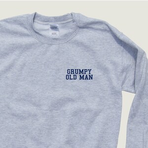 May include: A gray sweatshirt with the text "GRUMPY OLD MAN" in blue lettering.