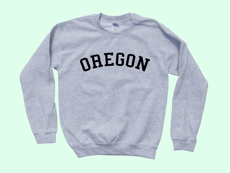 May include: A gray sweatshirt with the word "OREGON" printed in black on the front.