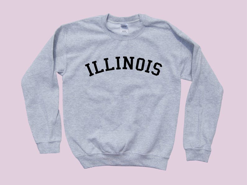 May include: A gray sweatshirt with the word "ILLINOIS" printed in black across the chest in an arched font.