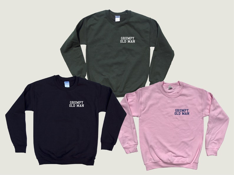 May include: Three sweatshirts in different colors: black, green, and pink. Each sweatshirt has the text "GRUMPY OLD MAN" embroidered on the front in white or blue.
