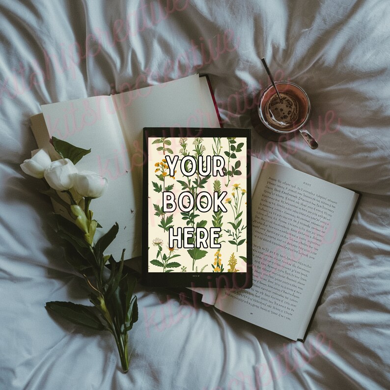 K&ouml;nnte beinhalten: Ein Tablet-Computer mit einem floralen Hintergrundmuster und dem Text "YOUR BOOK HERE" auf dem Bildschirm. Das Tablet liegt auf einem wei&szlig;en Bettlaken mit einem Buch und einer Tasse Kaffee.