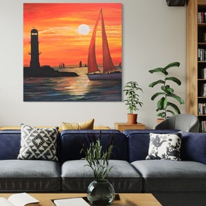 May include: A painting of a sailboat with a red sail sailing away from a lighthouse at sunset. The sky is a vibrant orange and yellow, and the water is a deep blue.
