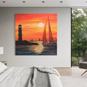 May include: A painting of a sailboat with a red sail sailing away from a lighthouse at sunset. The sky is orange and yellow, and the water is blue and green.
