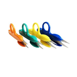 May include: Four pairs of small, colorful fingertip scissors with silver blades. The scissors are orange, green, yellow, and blue.