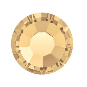May include: A single, round, gold-coloured rhinestone with a faceted design.