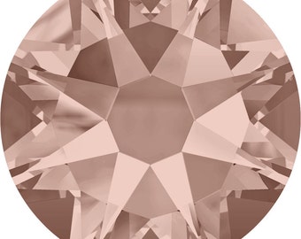 May include: A single, round, rose gold-colored rhinestone with a faceted design.
