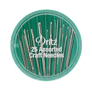 May include: A round, clear plastic container with a green lid filled with 25 assorted craft needles. The container has the text "Dritz 25 Assorted Craft Needles" printed on it.