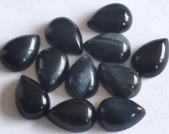May include: A collection of twelve teardrop-shaped black tiger's eye gemstone cabochons. The stones have a dark, iridescent sheen.