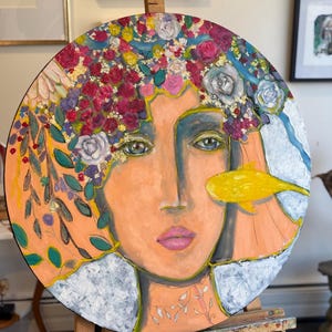 Round painting on canvas, a face of a young woman with flowers in her hair. It is an original oil painting with bright warm colours. Stylize