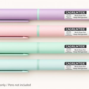 May include: Four pastel-coloured multi-dose pens: lavender, pink, mint green, and teal. Each pen has a white label with the text "CAGRILINTIDE", "Multi-Dose Pen", and "10mg". The pens have a matching coloured cap and clip. The text "Labels only / Pens not included" is at the bottom.