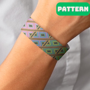 May include: A woven bracelet with a geometric pattern in shades of brown, green, and purple. The bracelet is on a person's wrist.