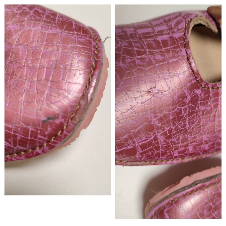 May include: Close-up of a pair of pink leather shoes with a cracked finish. The shoes have a gold stitching detail around the edges.