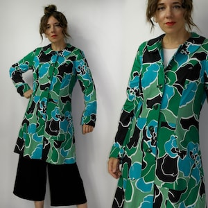 May include: A long-sleeved, green, blue, and black floral print coat with a peter pan collar and button closure.