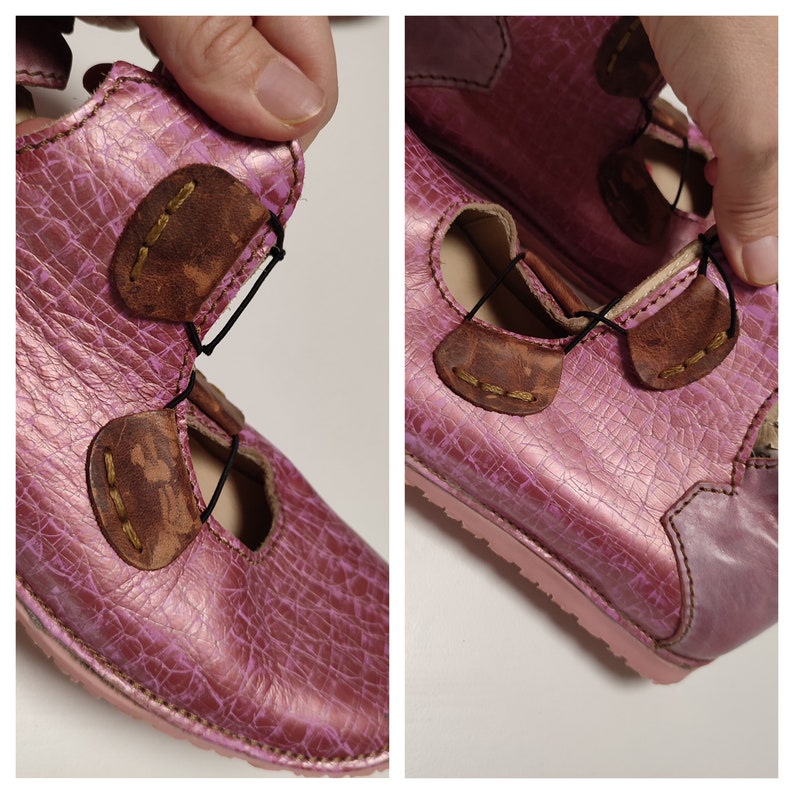 May include: Pink leather sandals with brown leather straps and buckles. The sandals have a textured surface and a rounded toe.