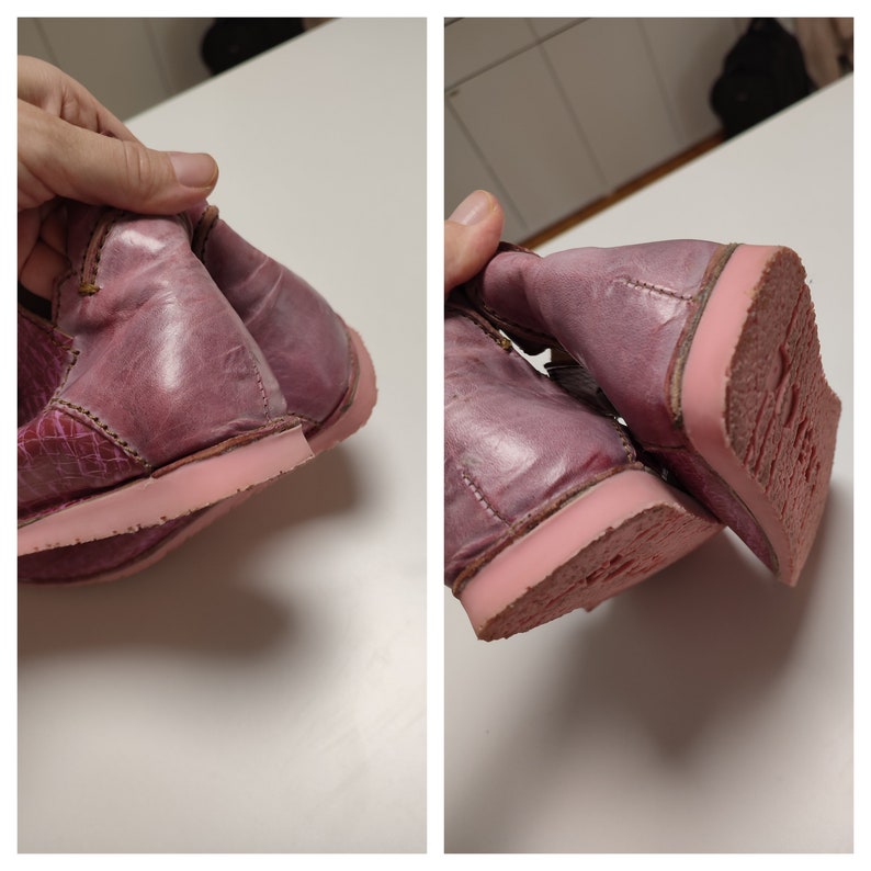 May include: A pair of pink leather boots with a pink rubber sole. The boots are worn and have a distressed look.