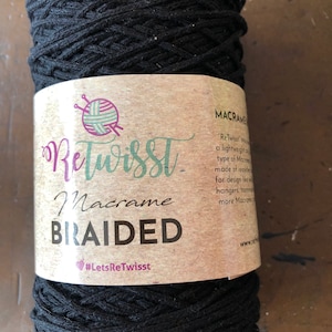 May include: A spool of black braided macrame cord with a label that reads "ReTwisst Macrame BRAIDED #LetsReTwisst".