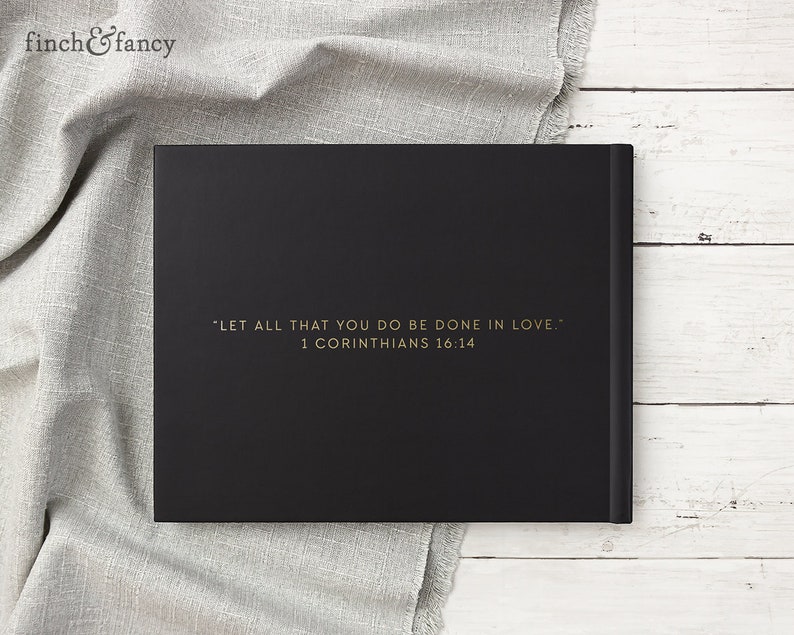 May include: Black hardcover journal with gold lettering on the front. The text reads "LET ALL THAT YOU DO BE DONE IN LOVE." 1 Corinthians 16:14