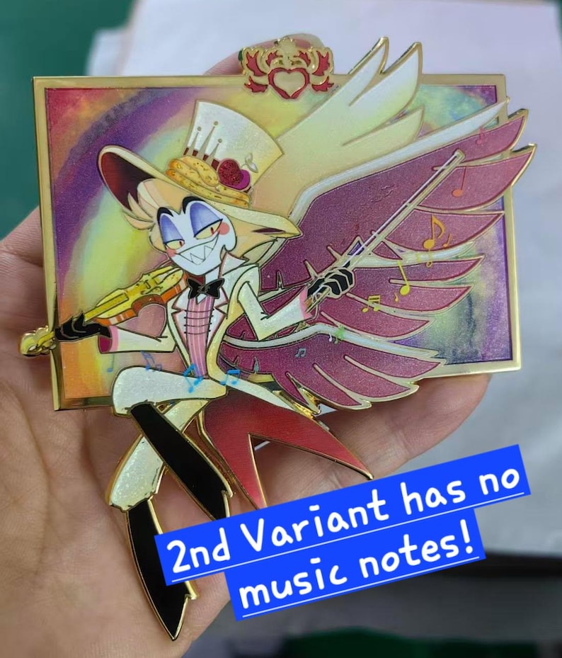 May include: A colorful enamel pin featuring a cartoon character with a top hat, wings, and a violin. The character is dressed in a white suit with a pink vest and black pants. The pin has a gold border and the text "2nd Variant has no music notes!"