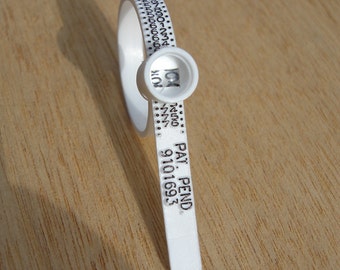 May include: White plastic cable tie with a numbered ring and the text "PAT. PEND. 9101693".