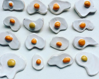 Egg brooches