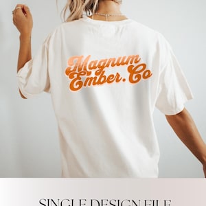 May include: Cream-colored t-shirt with the text "Magnum Ember. Co" in orange and peach retro font on the back. The shirt is a relaxed fit. Below the shirt is the text "SINGLE DESIGN FILE" and "PNG SUBLIMATION".