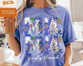 May include: A blue t-shirt with the word "MAMA" in white letters, each letter filled with floral designs in shades of blue, pink, and green. The words "simply blessed" are written in white script below the letters. The shirt is a casual style.