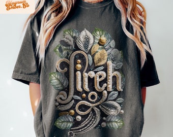 May include: A dark gray t-shirt with a graphic design of the word "fireh" in gold and black lettering surrounded by green and gold leaves.