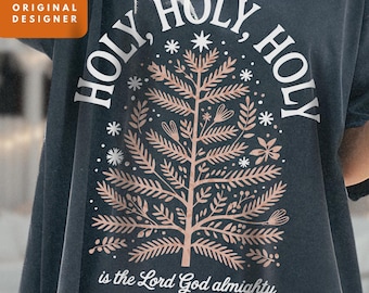 May include: Dark grey t-shirt featuring a copper-coloured tree design. The words "HOLY, HOLY, HOLY" are arched above the tree, with "is the Lord God almighty" below. Includes "2 PNG BUNDLE!" text.