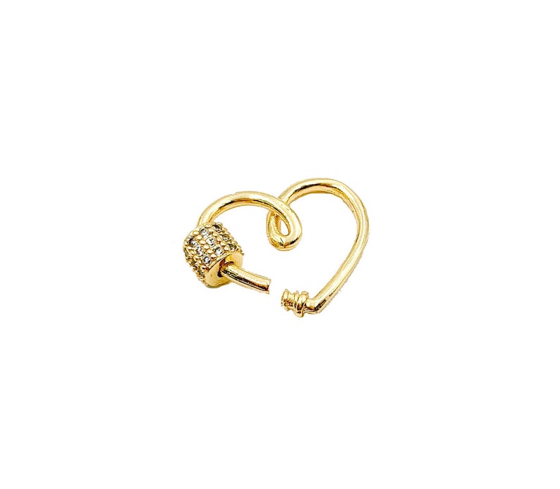 May include: Gold heart-shaped clasp with a clear crystal-encrusted barrel. This clasp is a jewelry finding for making necklaces, bracelets, and other jewelry.