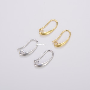 May include: Two pairs of earring hooks, one pair is gold and the other is silver. The hooks are made of metal and have a simple, elegant design.