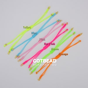 May include: Eight neon colored cords with gold beads and clasps. The cords are arranged in a rainbow pattern from yellow to orange. The text "GOTBEAD BEAD FOR YOU" is printed below the cords.