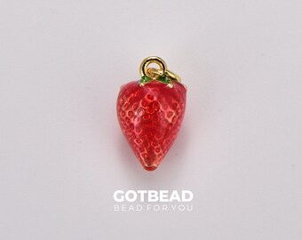 May include: A red enamel strawberry charm with a gold-tone finish and a green leaf. The charm is perfect for adding a touch of whimsy to jewelry or crafts.