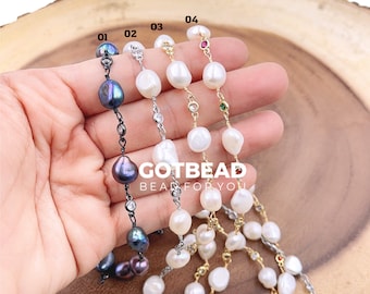 May include: Four pearl necklaces with different colored accents. The necklaces are made with white pearls and have black, silver, gold, and black chains. The accents are small red, green, and black gemstones.