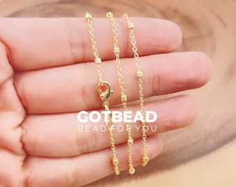 May include: A delicate gold-colored necklace with a lobster clasp and small beaded accents. The chain is shown against a neutral background. The text "GOTBEAD BEAD FOR YOU" is visible in white.