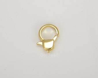 May include: Gold-toned metal lobster clasp with a spring-loaded closure. The clasp is designed for attaching to jewelry or other items.