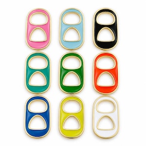 May include: A collection of nine soda can tab charms arranged in a three-by-three grid. Each charm features a gold-toned metal border surrounding a smooth, colorful enamel inlay in pink, light blue, black, teal, green, orange, blue, yellow, and white.