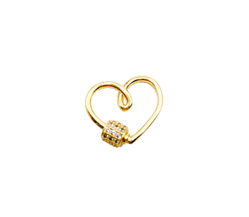 May include: Gold heart-shaped charm with a clear crystal-encrusted barrel clasp.