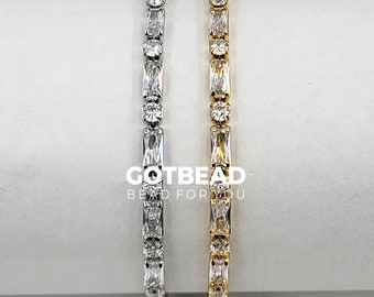 Puede incluir: Dos pulseras de plata y oro con piedras de circonita cúbica transparentes. Las pulseras están sobre una superficie blanca. GOTBEAD Bead for You está impreso en la superficie.