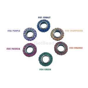 May include: Six round metal bead charms with different colored rhinestones. The beads are labeled with numbers and colors: #01 Cobalt, #02 Champagne, #03 Orange, #04 Green, #05 Fuchsia, and #06 Purple.