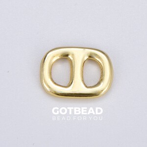 May include: Gold-toned metal connector with two oval-shaped holes. The connector is a popular jewelry making component.