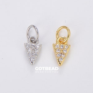May include: Two silver and gold triangle charms with clear crystal accents. The charms have a loop at the top for attaching to jewelry.