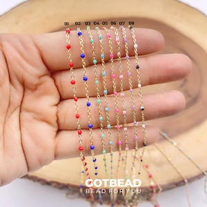 May include: A close-up of a hand holding eight gold chains with different colored beads. The chains are numbered 01 through 08. The text "GOTBEAD BEAD FOR YOU" is visible at the bottom of the image.