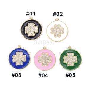 May include: Five gold-tone charms with a four-leaf clover design. Each charm has a different colored enamel background: black, white, blue, pink, and green. The charms are labeled #01 through #05.