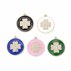 May include: Five gold-tone charms with a four-leaf clover design. Each charm has a different colored enamel background: black, white, blue, pink, and green.