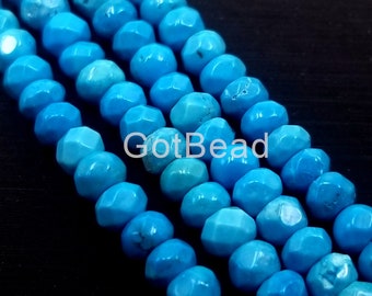 May include: A strand of turquoise blue faceted beads. The beads are round and have a smooth, polished finish. GotBead is printed on the beads.