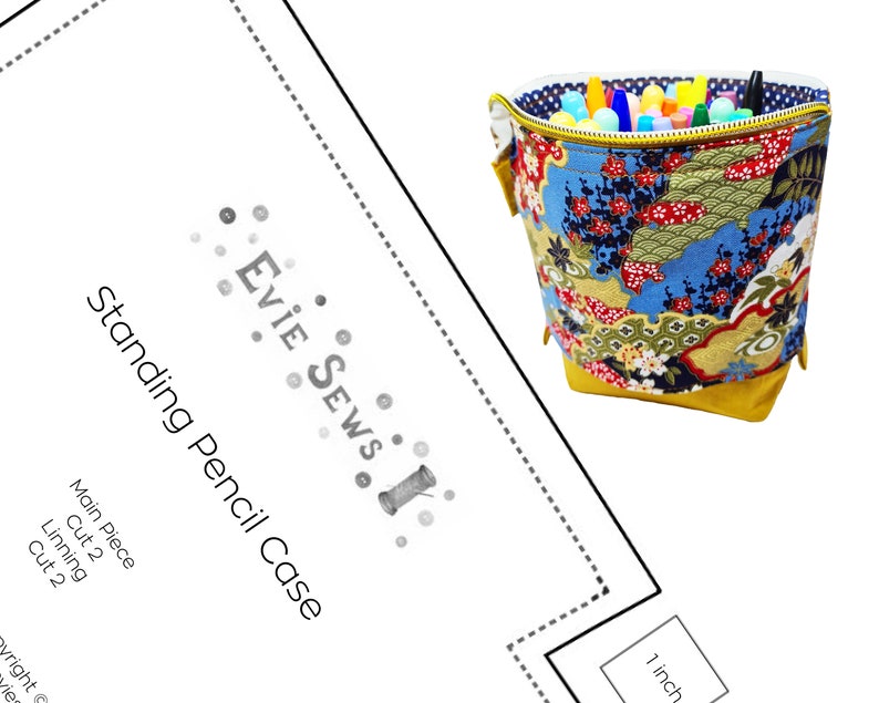 May include: A sewing pattern for a standing pencil case. The pattern includes instructions for cutting out the main fabric and lining pieces. The pattern is titled "Standing Pencil Case" and includes the text "Evie Sews".