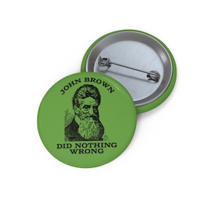May include: Green button with a black and white illustration of John Brown and the text "John Brown Did Nothing Wrong".